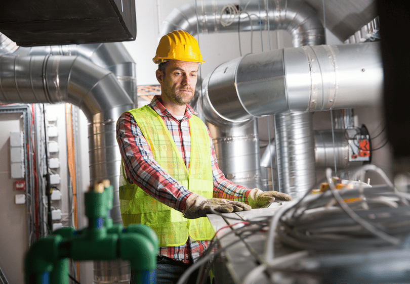 Technician working on HVAC Technician working on HVAC