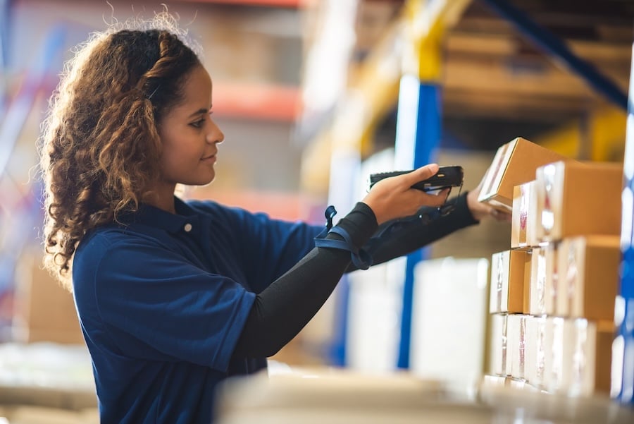 Woman Scanning Boxes in a Warehouse